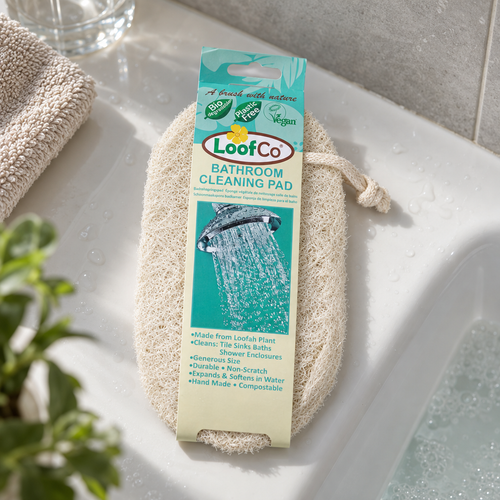 LoofCo loofah bathroom cleaning pad on a bath ledge