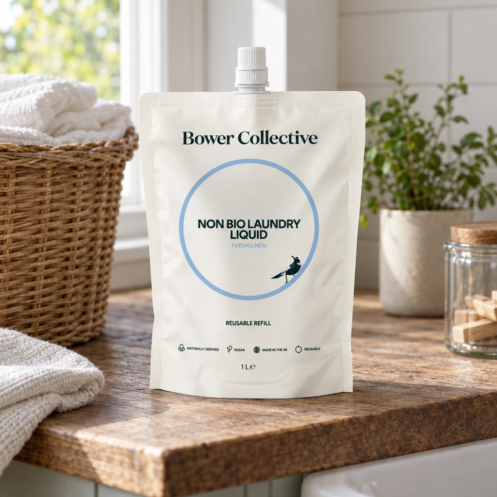 Bower Collective Non Bio Laundry Liquid Fresh Linen 1L refill pouch on an oak worktop