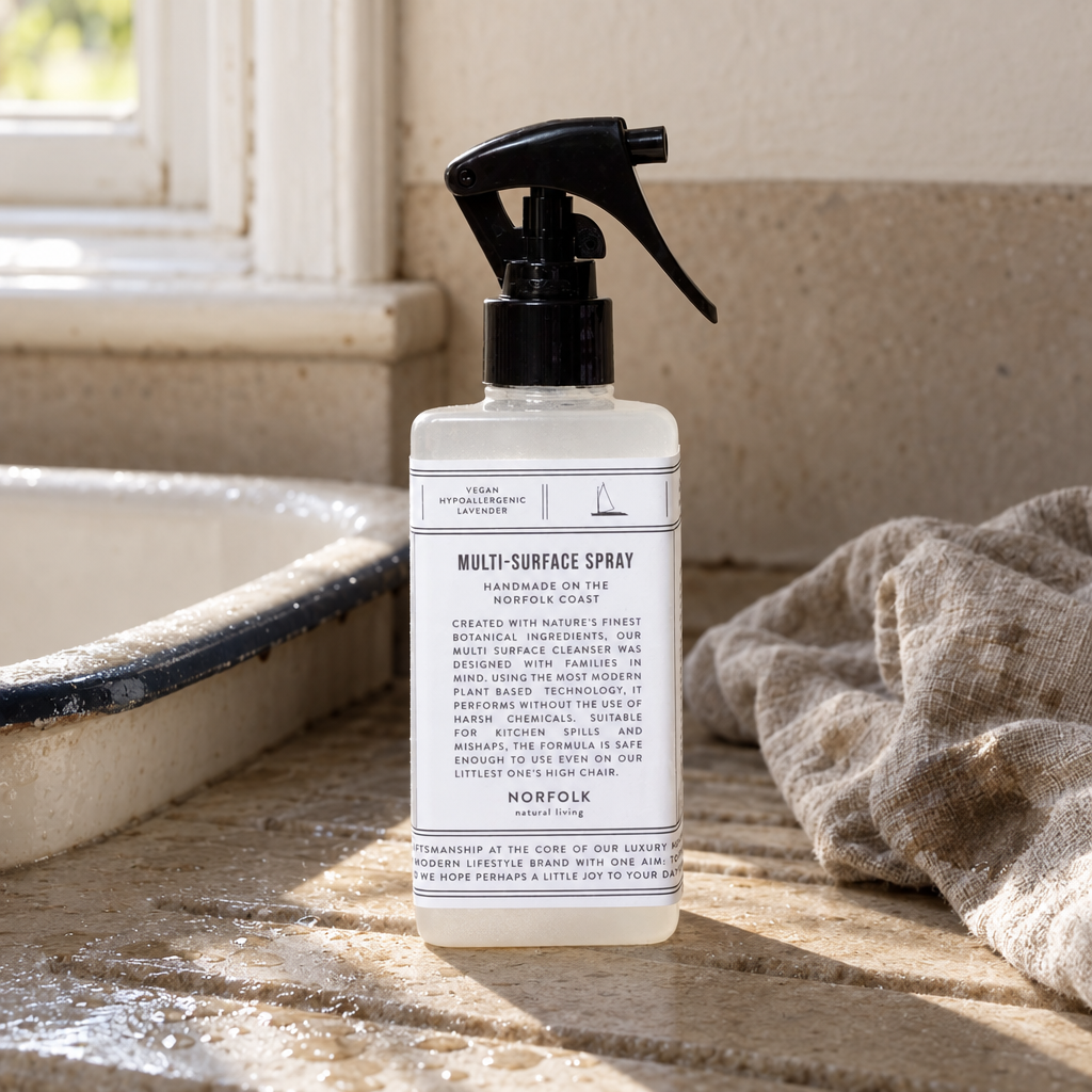 Norfolk Natural Living Multi-Surface Spray 300ml on a stone draining board beside an enamel sink