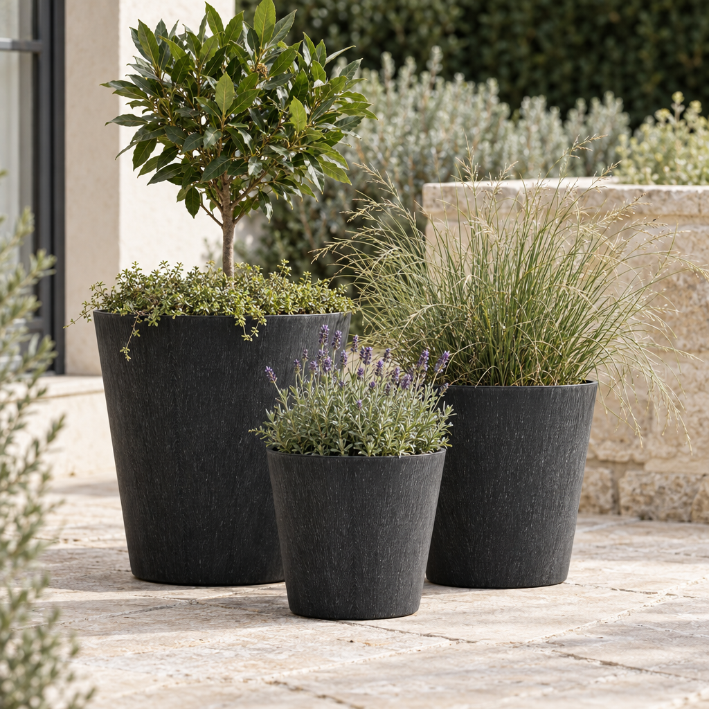 Trio of black Pula recycled planters on a limestone terrace