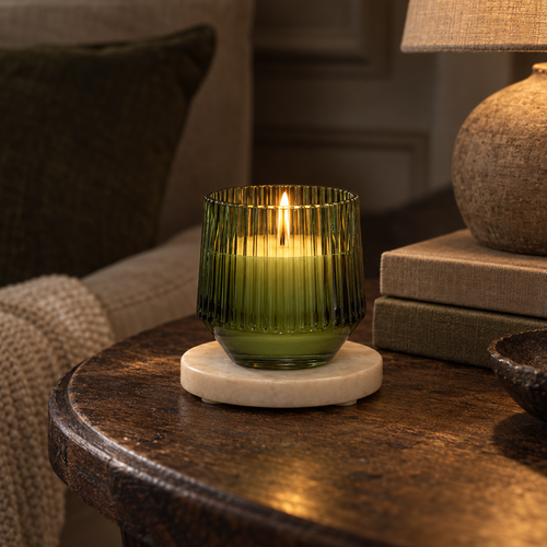 Sicilian Basil and Wild Lemon candle in ribbed green glass, lit