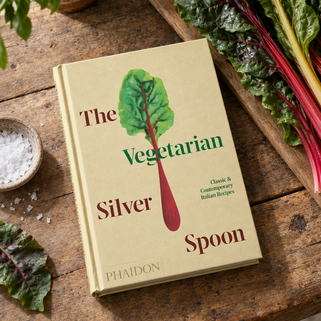 The Vegetarian Silver Spoon (Phaidon) on a walnut table with rainbow chard
