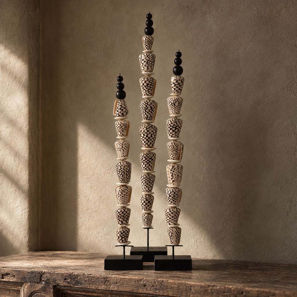Set of three Yoko shell sculptures on black stands
